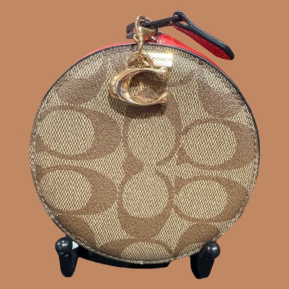 Coach Handbags - Coach Mini Round Wristlet with Red Trim
